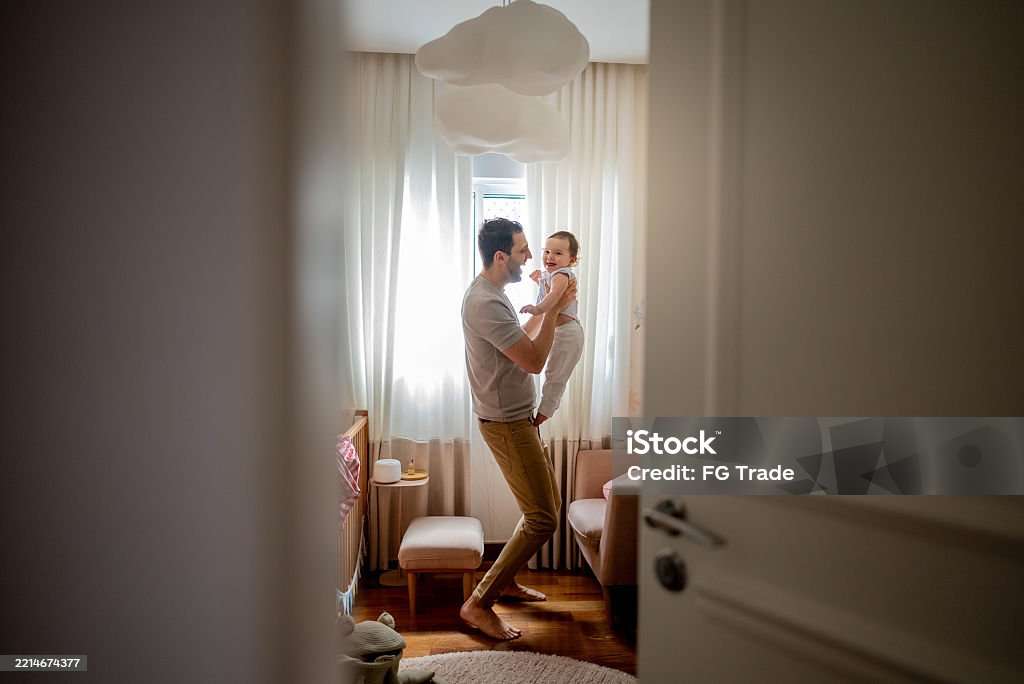 Father playing with his daughter at home